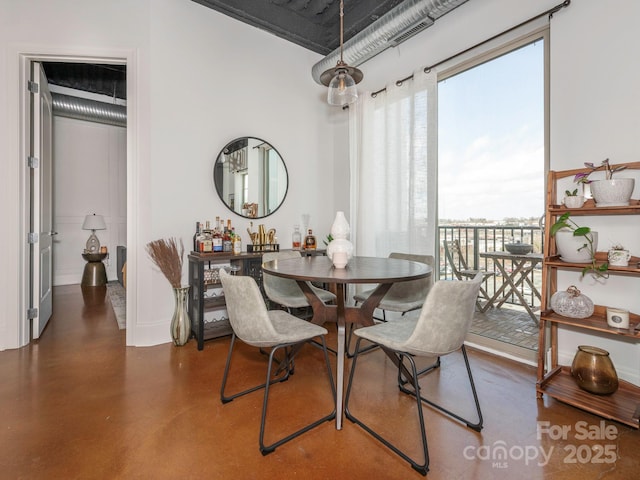 dining space featuring concrete flooring