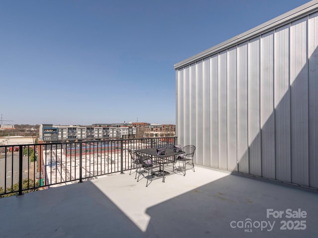 view of patio featuring a balcony