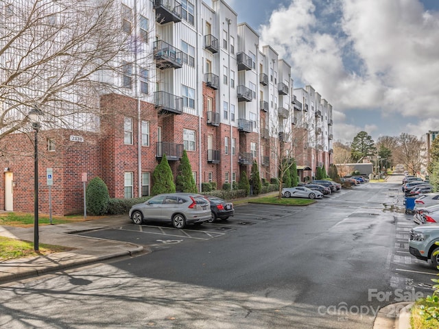 view of building exterior with uncovered parking