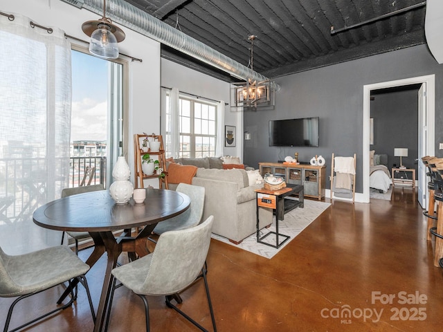 dining space with an inviting chandelier and finished concrete floors