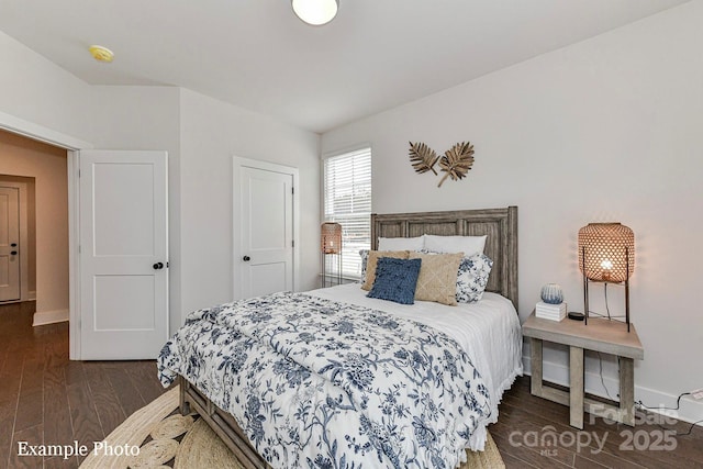 bedroom featuring wood finished floors and baseboards