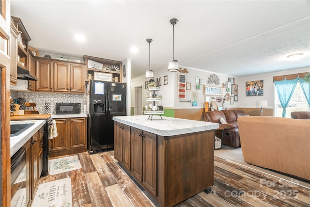 kitchen featuring decorative backsplash, open floor plan, wood finished floors, black appliances, and open shelves