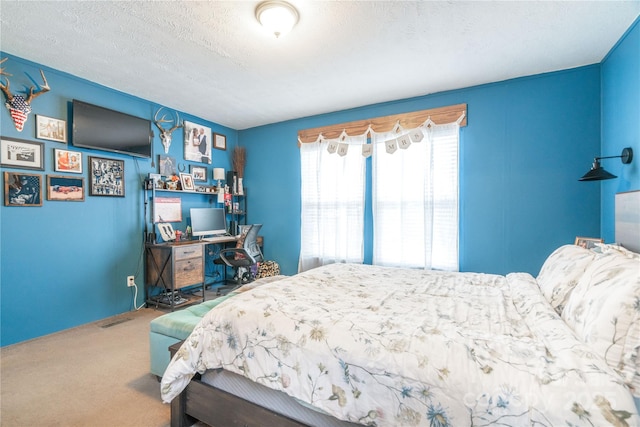 carpeted bedroom featuring visible vents and a textured ceiling