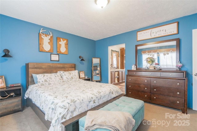 bedroom with connected bathroom and a textured ceiling