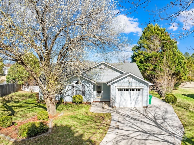 view of front facade featuring a garage, fence, a front lawn, and concrete driveway