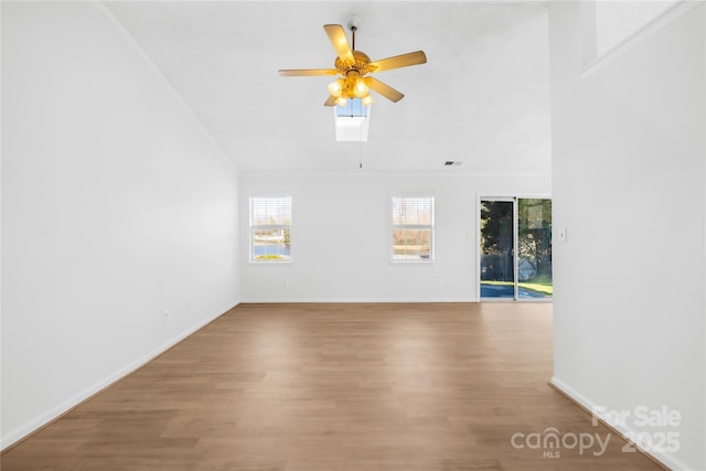 unfurnished living room with baseboards, ceiling fan, visible vents, and wood finished floors