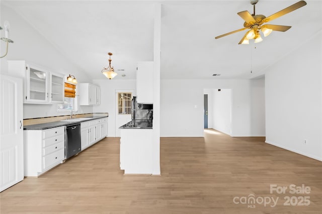 kitchen with white cabinets, light wood-type flooring, dishwasher, dark countertops, and glass insert cabinets