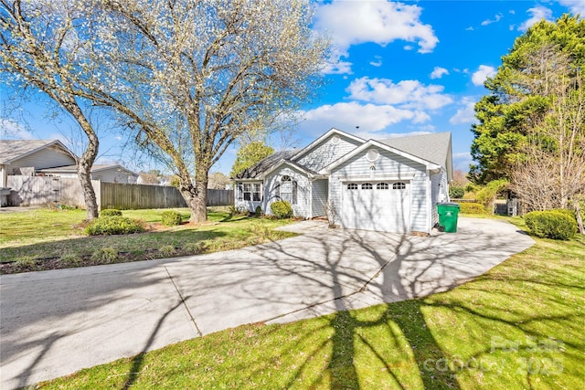 view of front facade with driveway, a garage, fence, and a front lawn