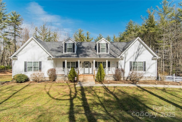 cape cod house with a front yard, covered porch, and fence