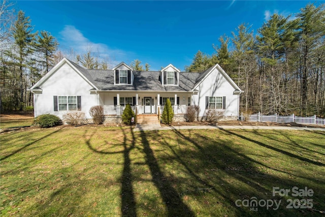 cape cod home featuring a porch, a front lawn, and fence