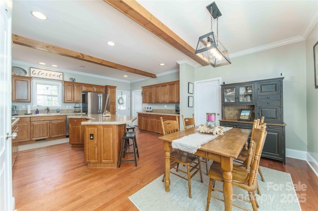 dining space with light wood-style flooring, recessed lighting, baseboards, ornamental molding, and beamed ceiling