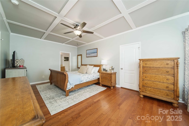 unfurnished bedroom with baseboards, coffered ceiling, a ceiling fan, wood finished floors, and beamed ceiling