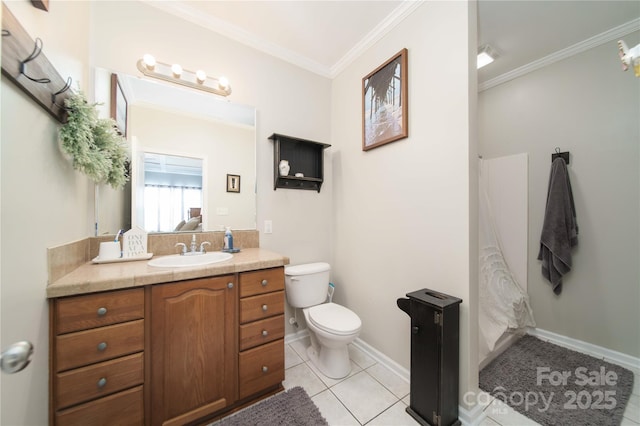 bathroom featuring tile patterned flooring, toilet, vanity, baseboards, and ornamental molding