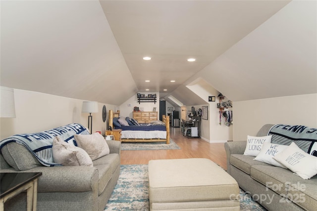 bedroom featuring lofted ceiling, wood finished floors, and recessed lighting