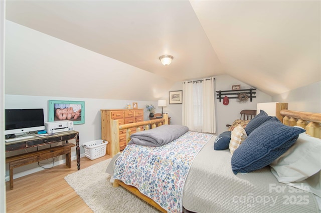 bedroom featuring lofted ceiling and wood finished floors