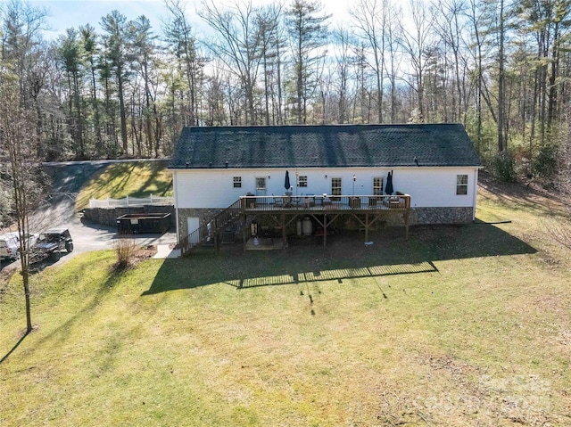 view of front of house featuring stairs, a front yard, and a wooden deck