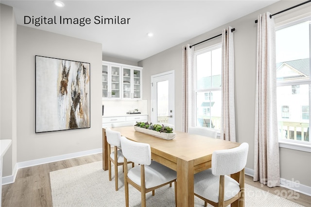 dining room with light wood-style flooring, baseboards, and recessed lighting