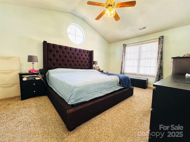 bedroom featuring lofted ceiling, visible vents, carpet flooring, and multiple windows