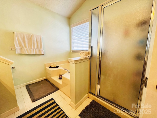 bathroom featuring a stall shower, lofted ceiling, a garden tub, tile patterned flooring, and a textured ceiling