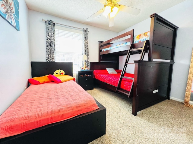 bedroom featuring carpet, a ceiling fan, and a textured ceiling