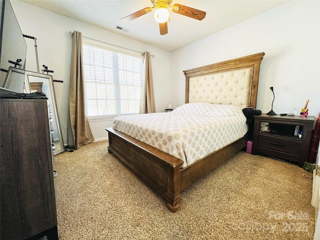 bedroom with visible vents, ceiling fan, light carpet, and baseboards