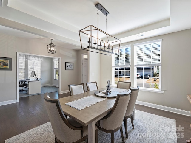 dining space featuring a wealth of natural light, dark wood-style floors, and baseboards