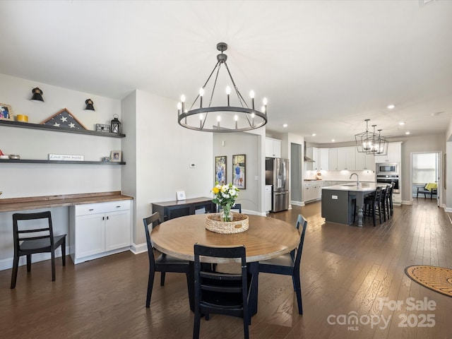 dining room featuring recessed lighting, baseboards, an inviting chandelier, and dark wood-style flooring