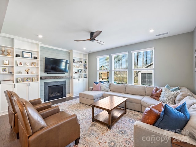 living room with visible vents, a ceiling fan, wood finished floors, recessed lighting, and a large fireplace