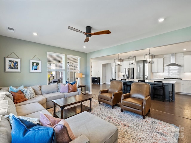 living room featuring dark wood finished floors, visible vents, recessed lighting, and a ceiling fan
