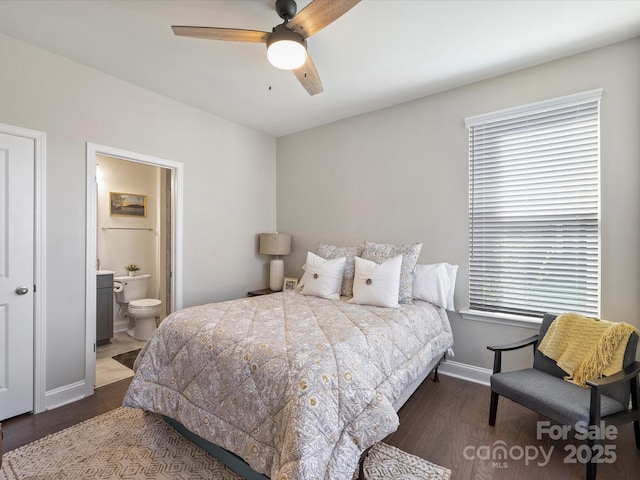 bedroom featuring baseboards, a ceiling fan, wood finished floors, and ensuite bathroom