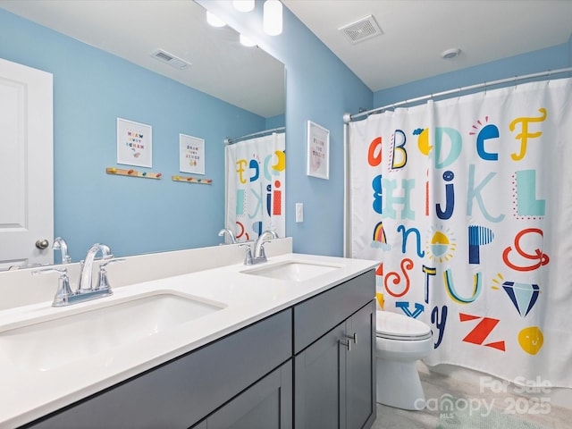 bathroom featuring a sink, visible vents, and toilet