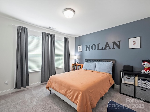 bedroom with carpet, visible vents, and baseboards