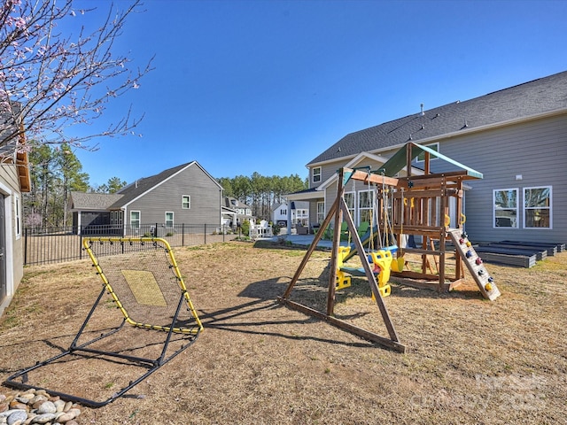 view of jungle gym featuring fence and a residential view