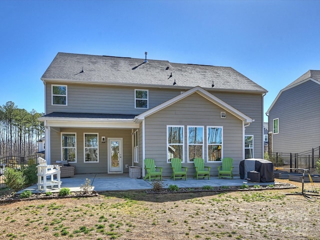 back of property featuring a patio and fence