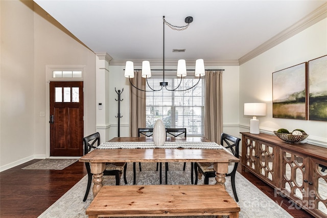 dining space with a wealth of natural light, an inviting chandelier, dark wood-style floors, and ornamental molding