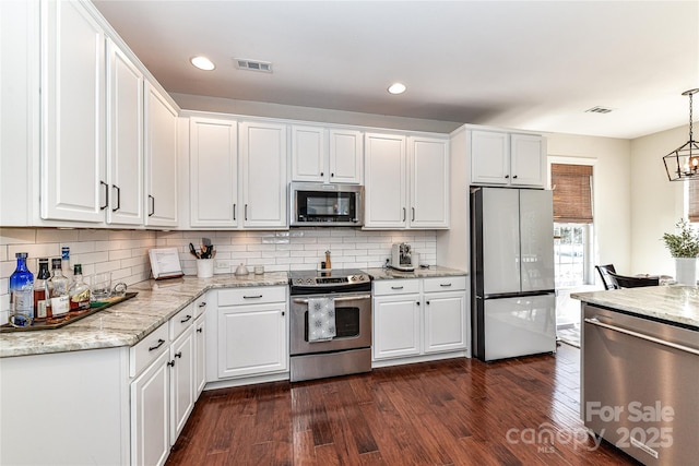 kitchen with visible vents, appliances with stainless steel finishes, dark wood-style flooring, and white cabinetry