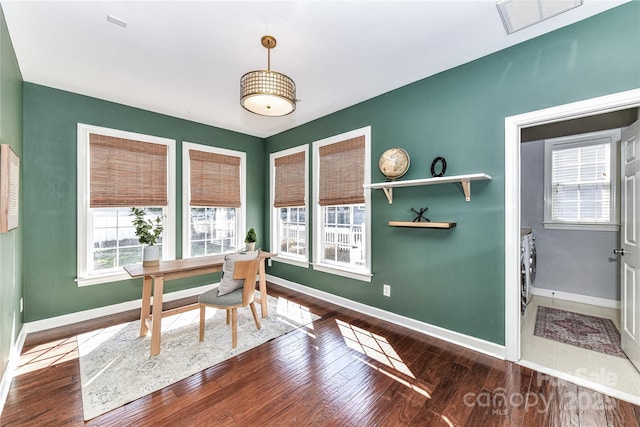 home office with visible vents, baseboards, and wood finished floors