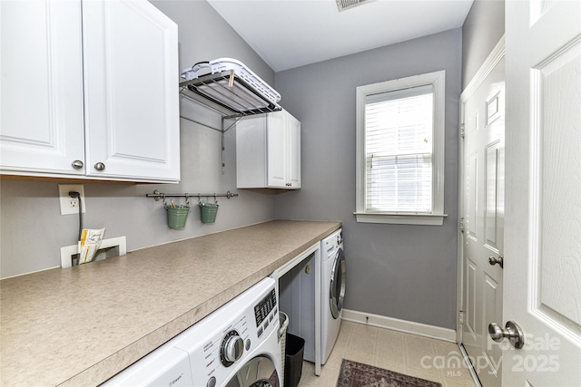 washroom featuring cabinet space, visible vents, washing machine and dryer, and baseboards