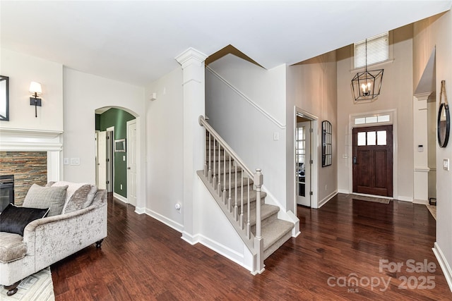 entrance foyer featuring stairs, wood finished floors, and baseboards