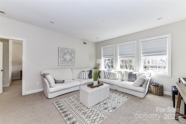 carpeted living room featuring visible vents and baseboards