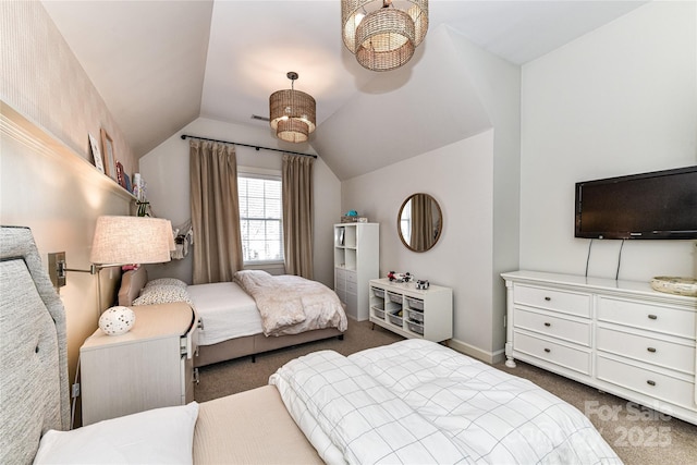 bedroom with dark colored carpet, baseboards, and vaulted ceiling