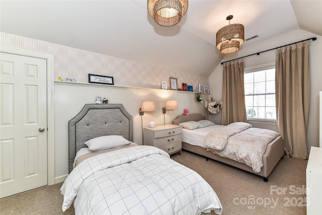 bedroom with visible vents, wallpapered walls, lofted ceiling, and carpet floors