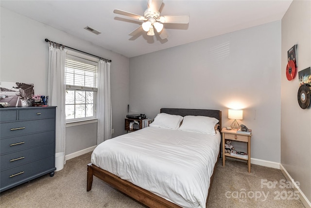 bedroom with light colored carpet, baseboards, visible vents, and a ceiling fan