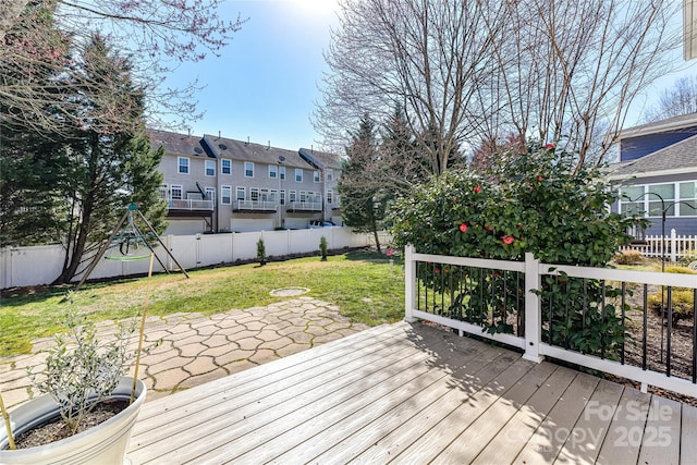 wooden deck with a yard, a residential view, a patio, and a fenced backyard