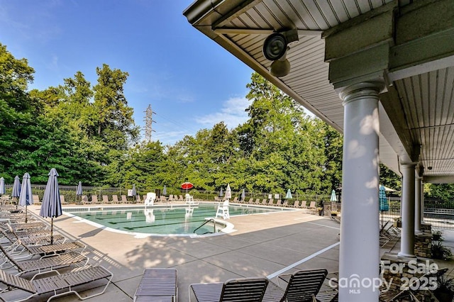 pool featuring a patio and fence