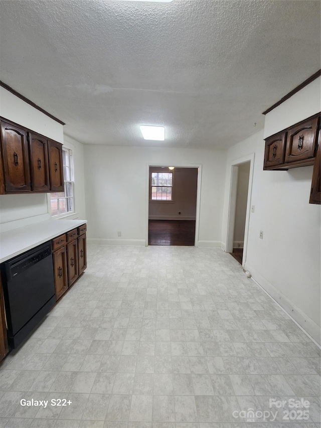 kitchen featuring light floors, light countertops, dark brown cabinets, dishwasher, and baseboards