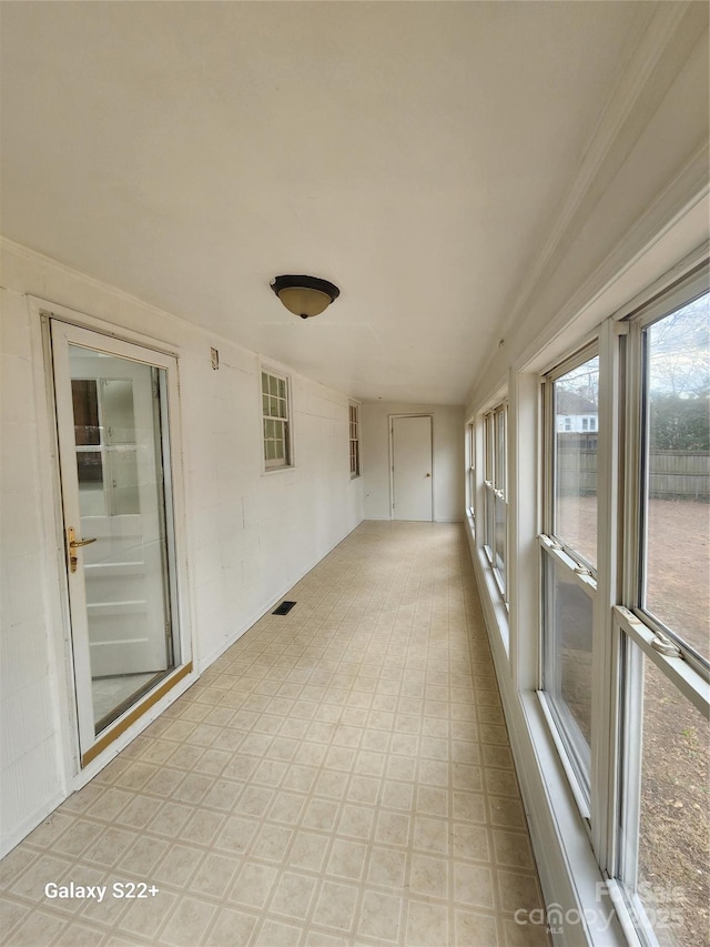 unfurnished sunroom with visible vents