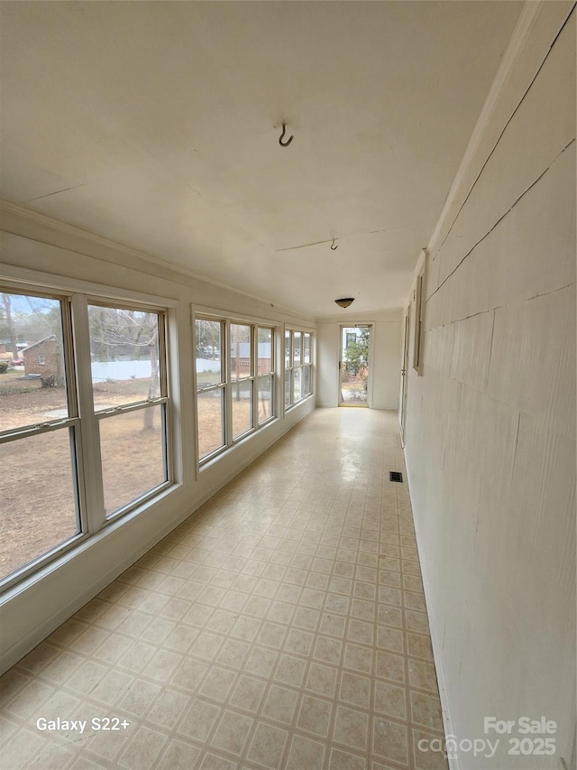 unfurnished sunroom with visible vents