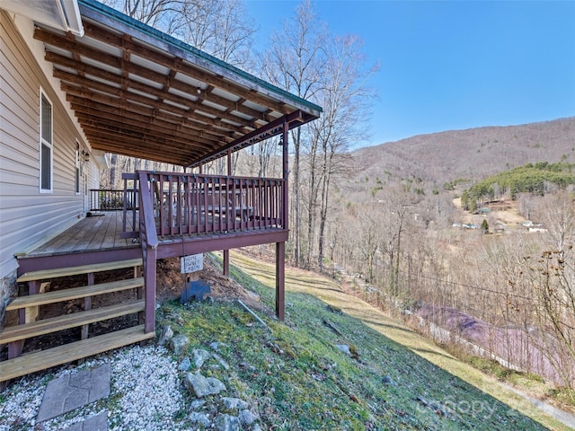 view of yard with a deck with mountain view