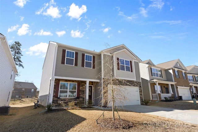 townhome / multi-family property with concrete driveway, cooling unit, stone siding, and an attached garage